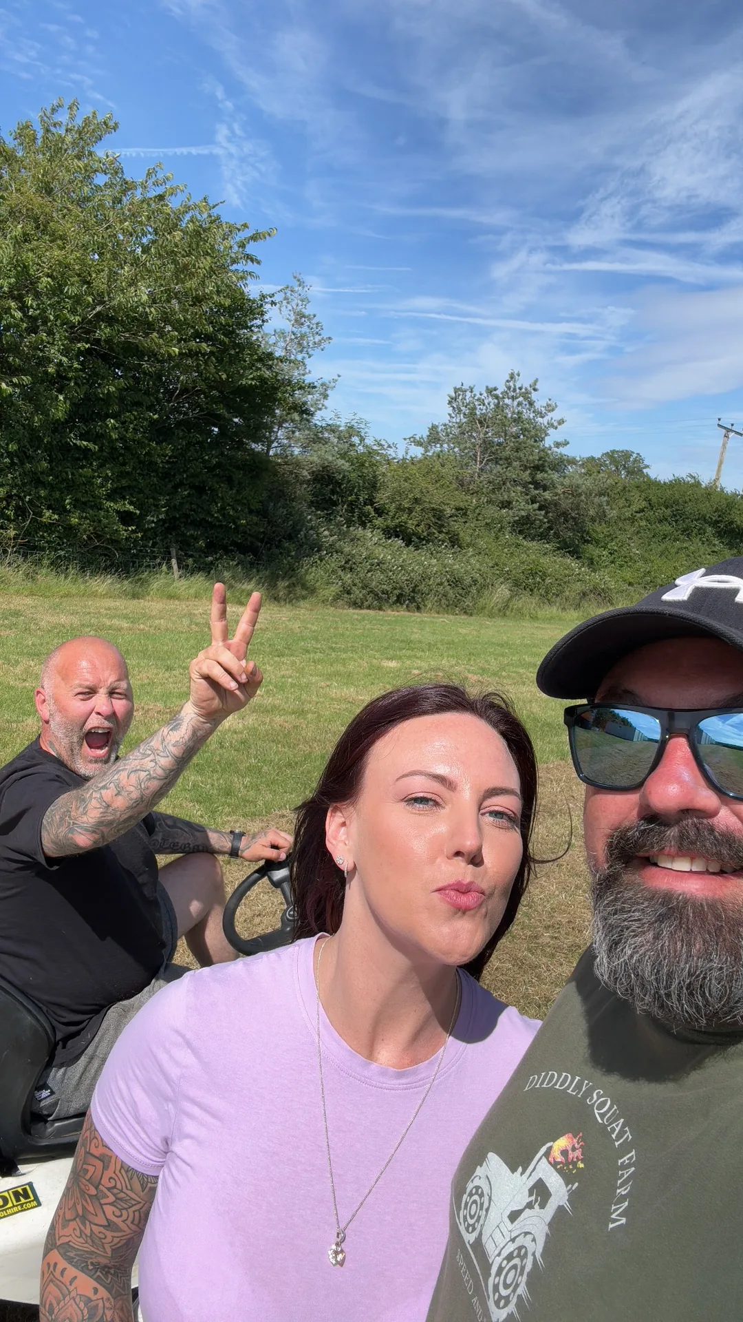 Friends posing on the field with blue sky