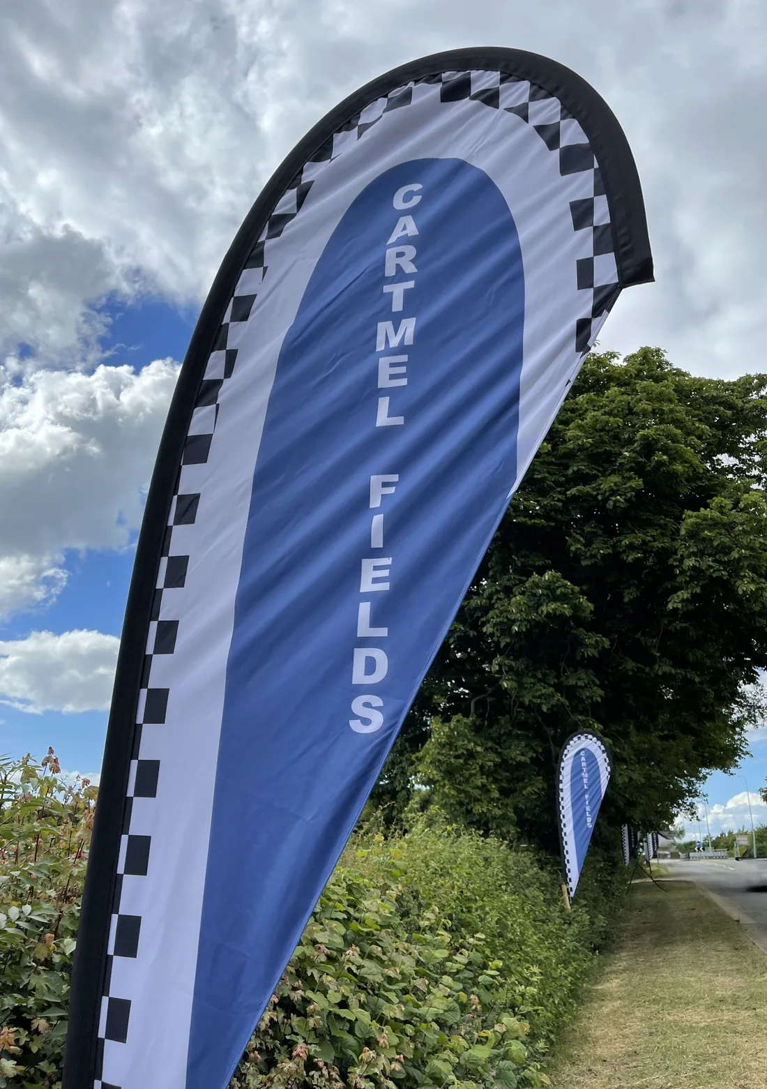 Cartmel Fields feather flag by the roadside