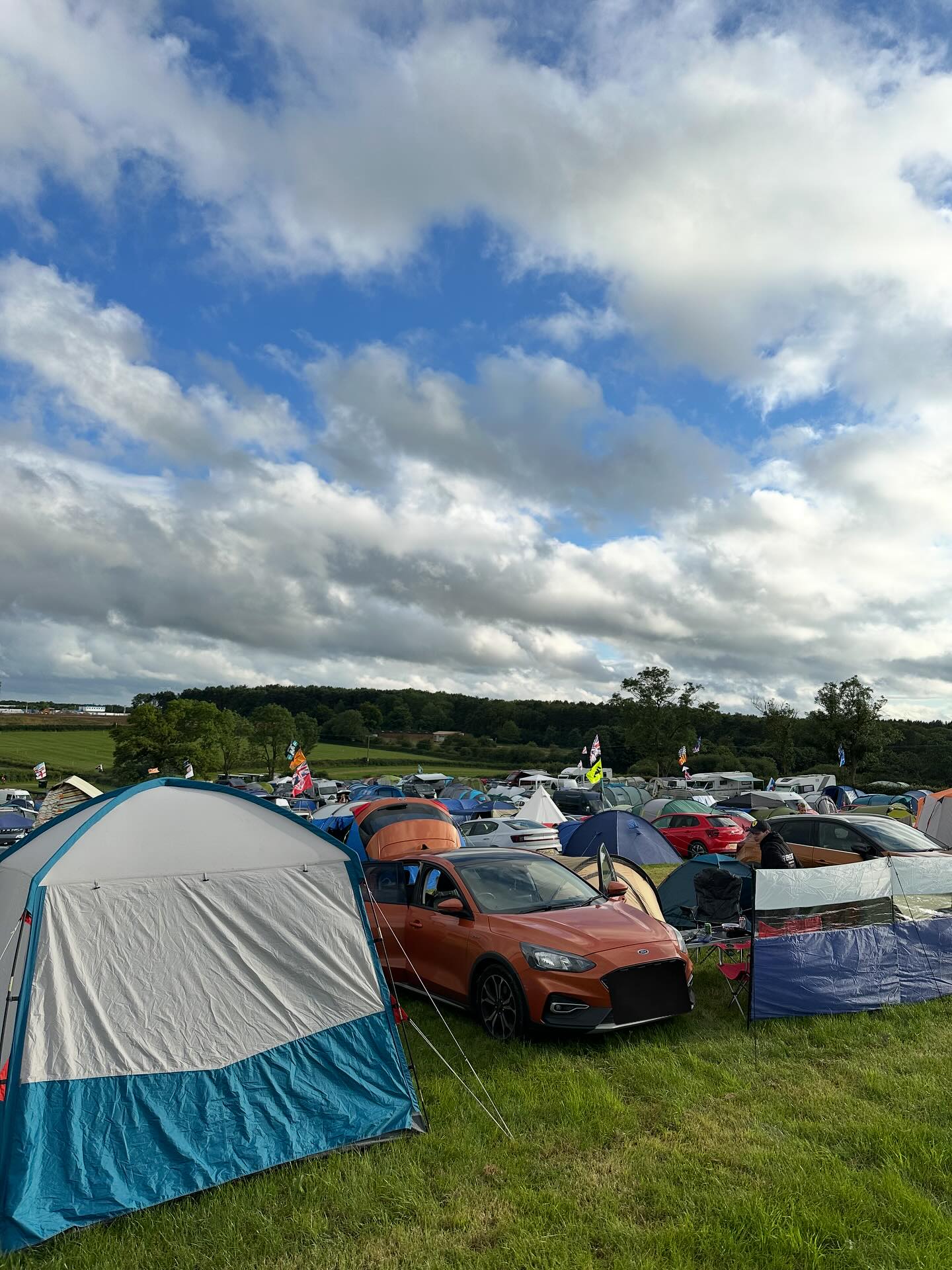 Campsite decorated with F1 team flags and banners