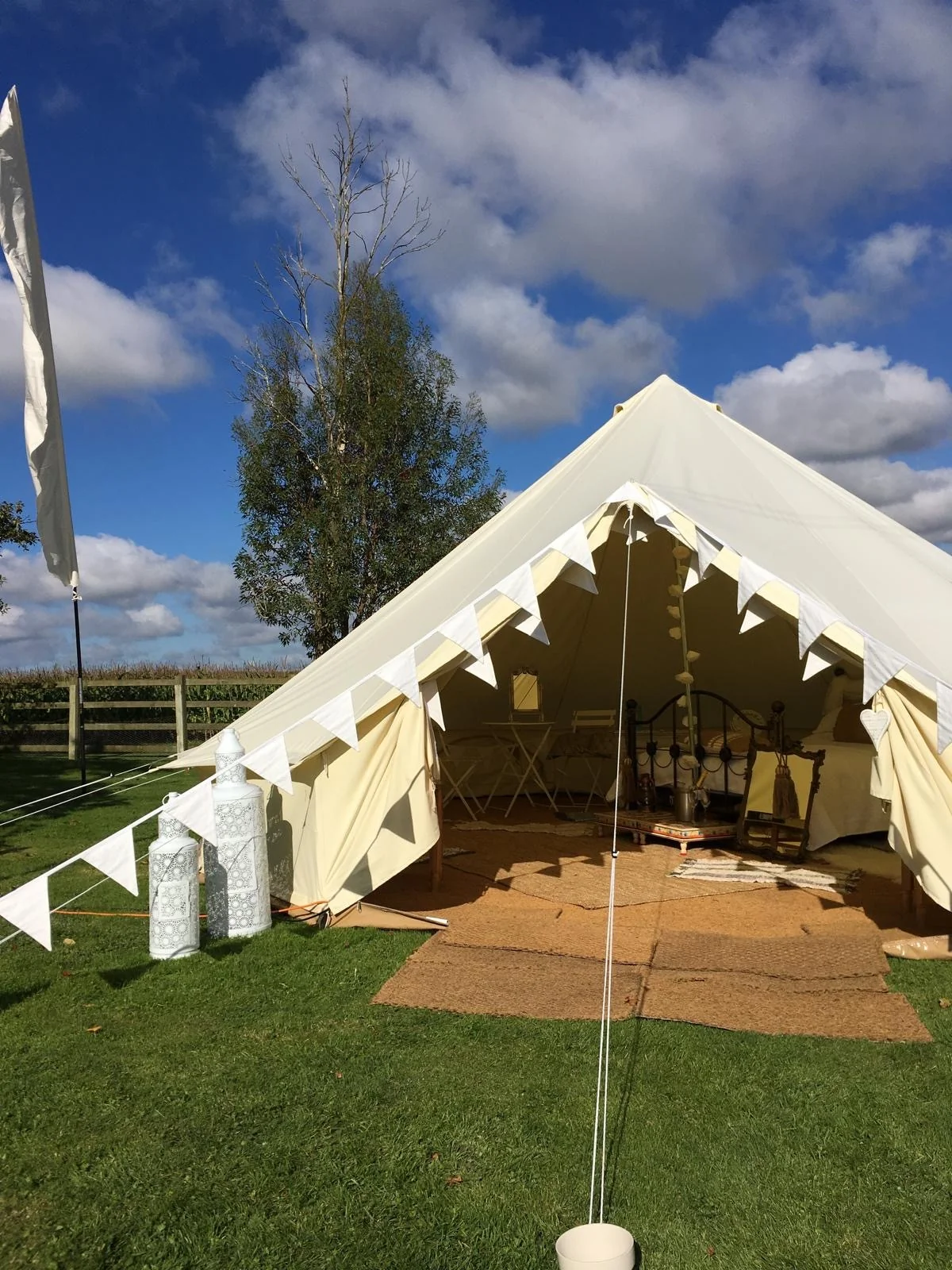 Bell tent exterior with bunting and welcoming entrance