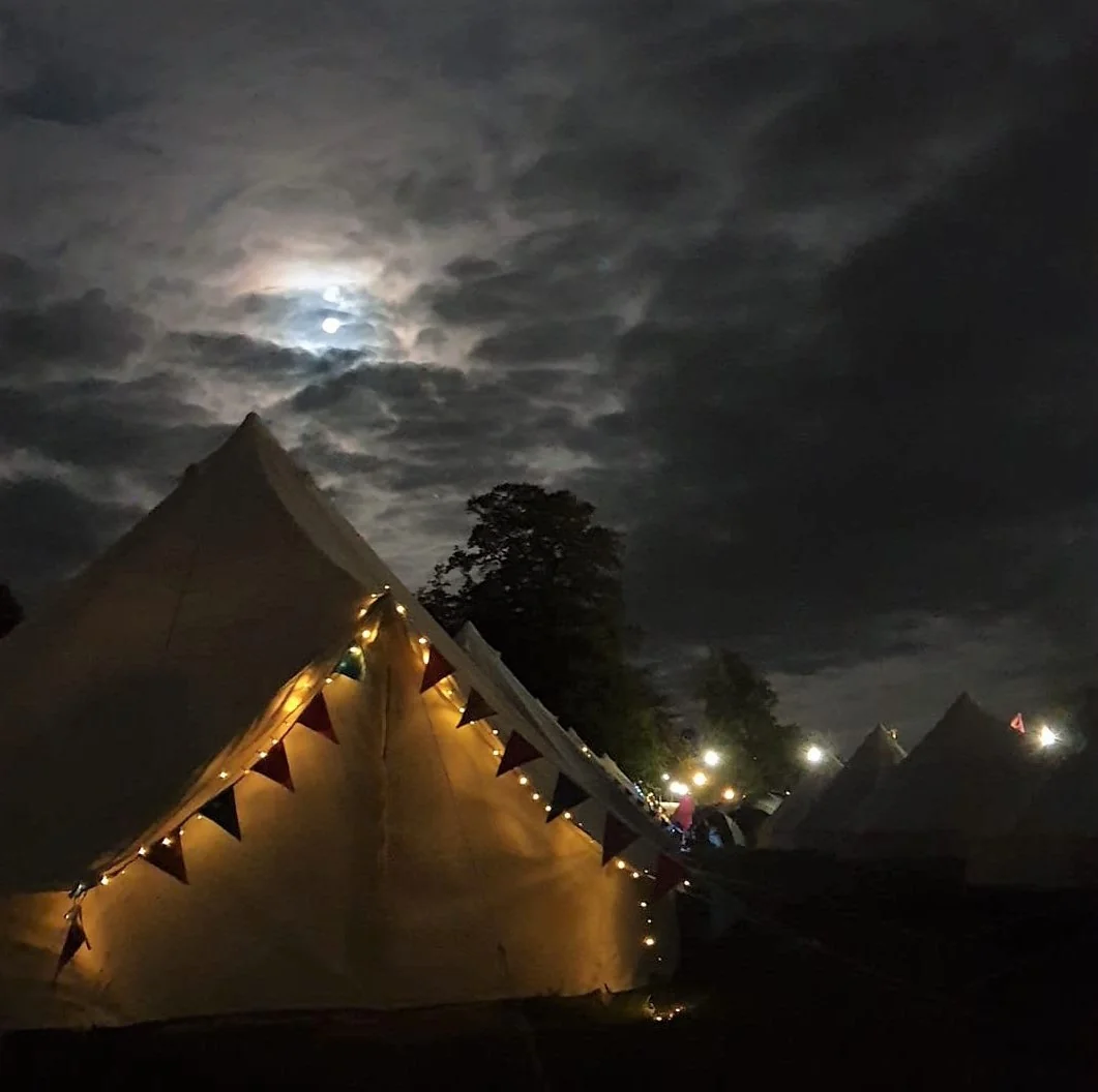 Cosy bell tent interior with cushions, guitar and bohemian decor