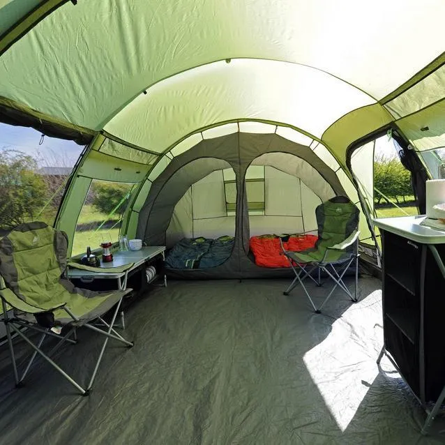 Spacious pre-pitched tent interior with camping chairs, table and living area