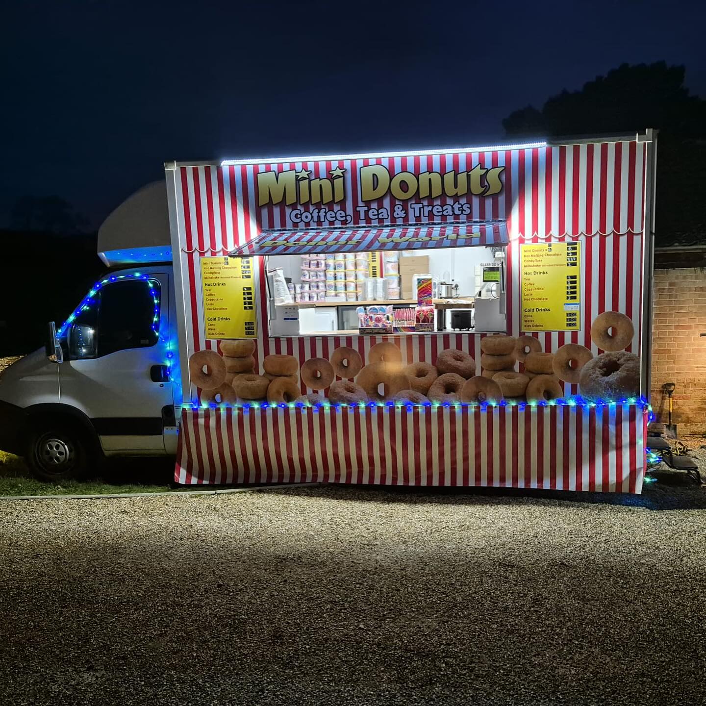Donut vendor at night with warm lighting and fresh treats