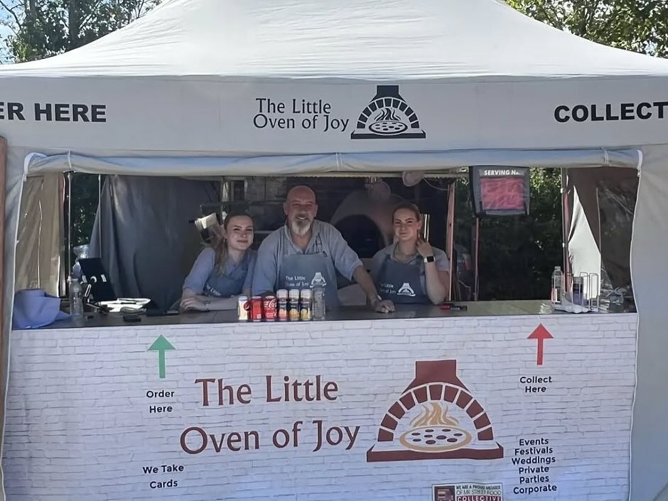 Friendly pizza vendor staff ready to serve customers