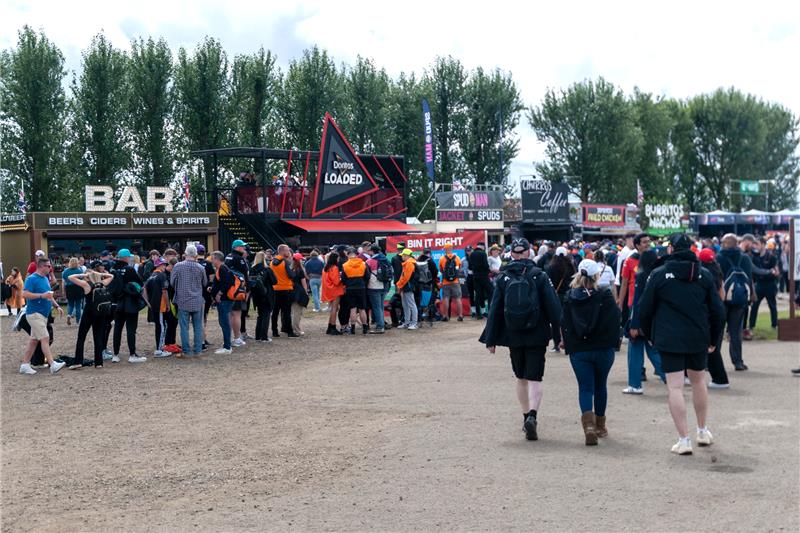 Crowds queueing at food vendors and bars in the Silverstone fan zone during British Grand Prix